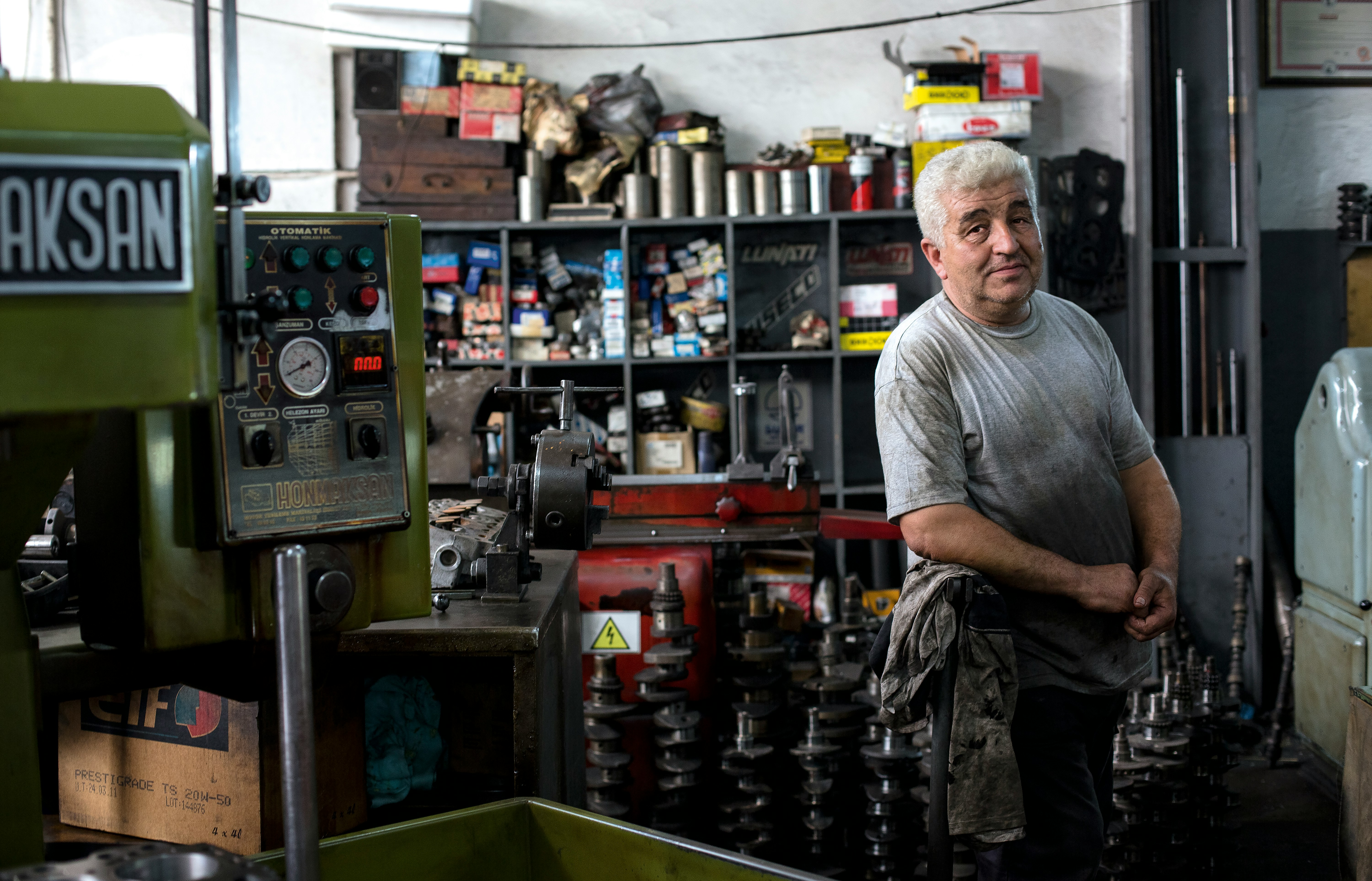 Shop owner smiles in his workplace. Photo by Alev Takil